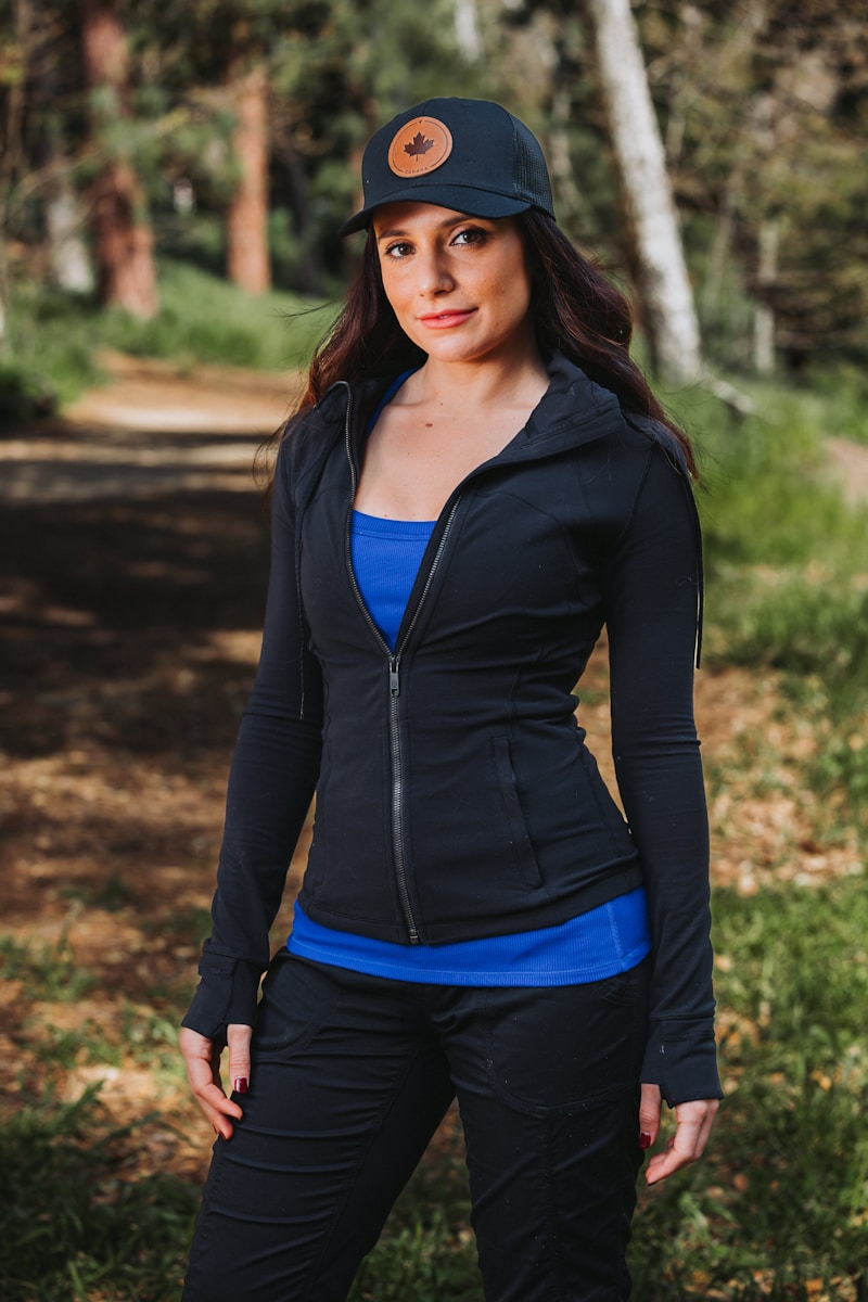 A woman wearing a black jacket and blue top